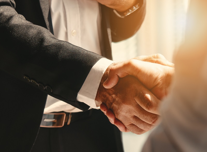 Two hands are held out to each other in greeting